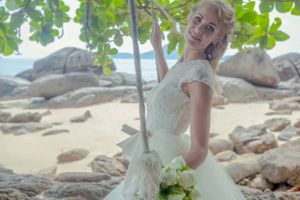 Schöne Mädchen in einem Hochzeitskleid auf der Schaukel im Hintergrund der andaman sea similan island — Stockfoto