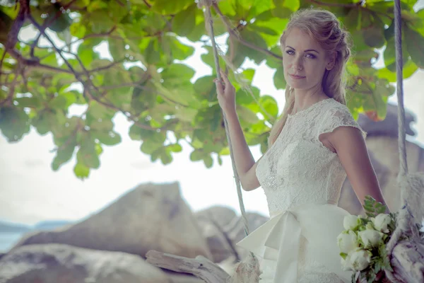 Beautiful girl in a wedding dress on the swing in the background of the Andaman sea Similan Island — Stock Photo, Image