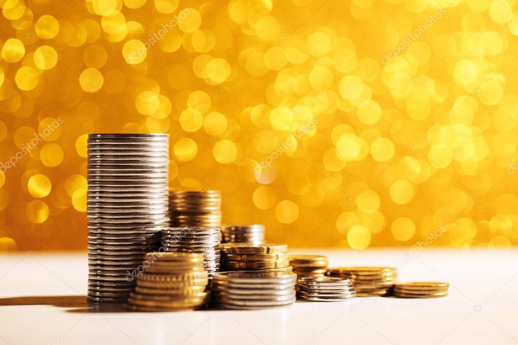 Coins stacks on golden background