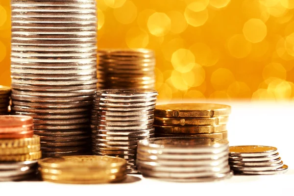 Monedas pilas con fondo bokeh dorado —  Fotos de Stock