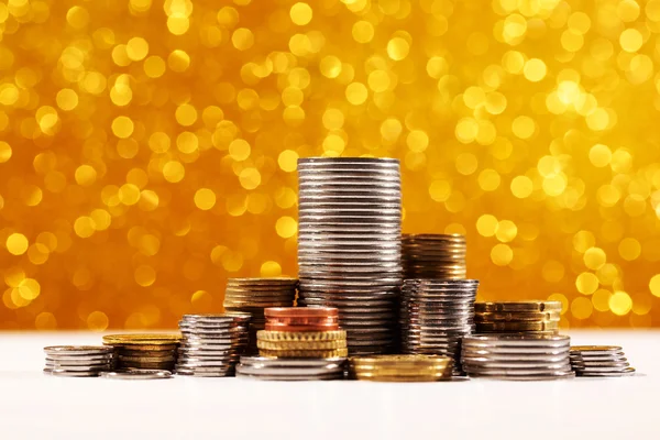 Coins stacks with golden bokeh background