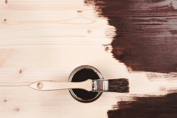 Paint can with brush on wooden background — Stock Photo, Image