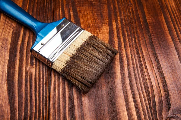 Paintbrush on wooden surface — Stock Photo, Image