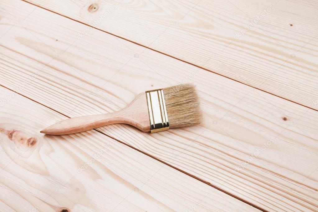 paintbrush on wooden surface