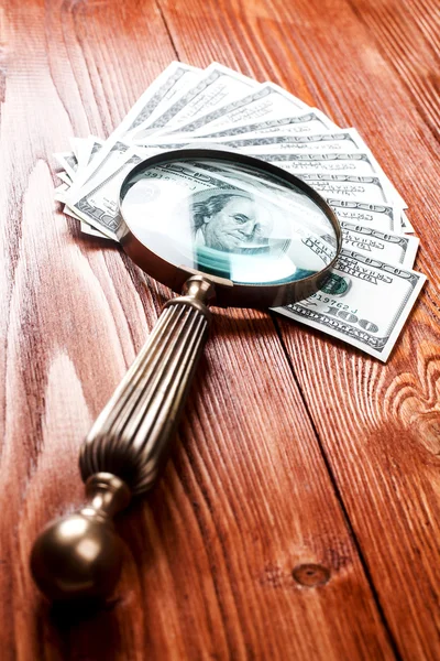 Dollars and magnifying glass — Stock Photo, Image