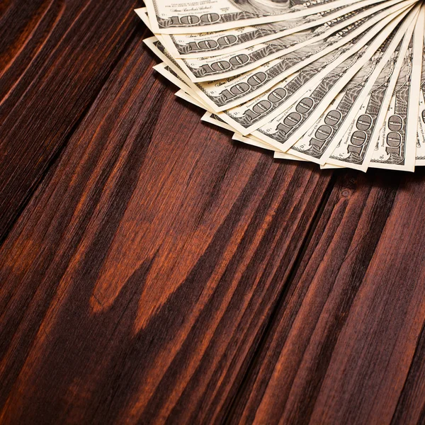 Dollars on wooden table — Stock Photo, Image