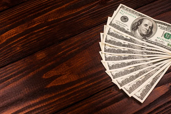 Dollari su tavolo di legno — Foto Stock