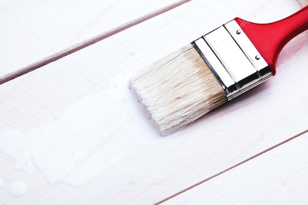 paintbrush on wooden surface