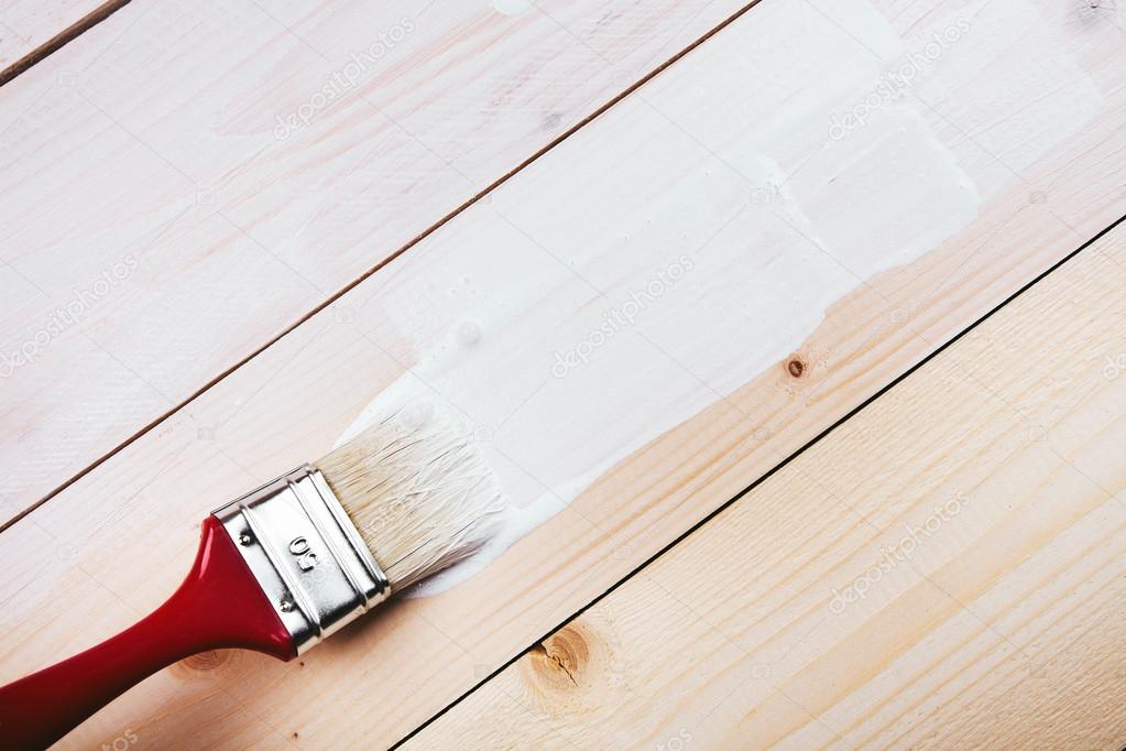 paint brush painting on wooden surface