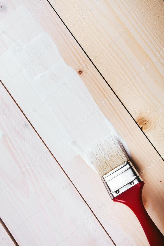 Varnishing a wooden shelf