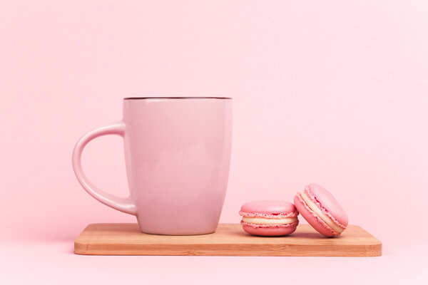 Pink macaroons with coffee