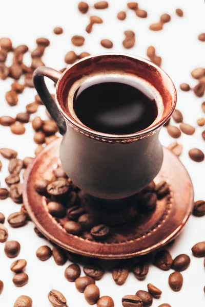 Vintage cup of coffee with beans — Stock Photo, Image