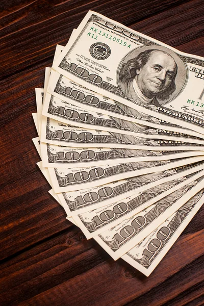 Dollars on wooden table — Stock Photo, Image