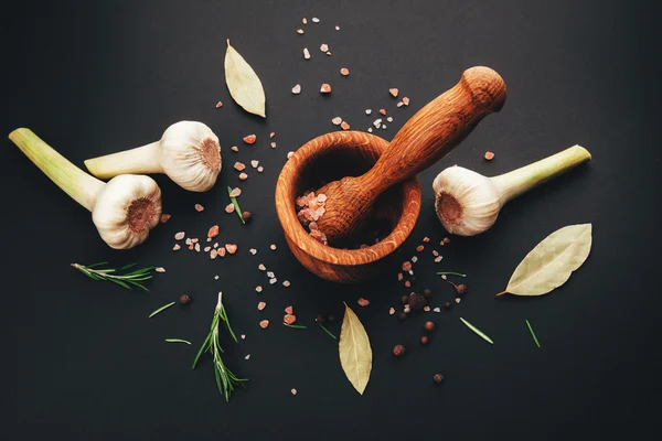 Fresh herbs and spices in wooden mortar — Stock Photo, Image