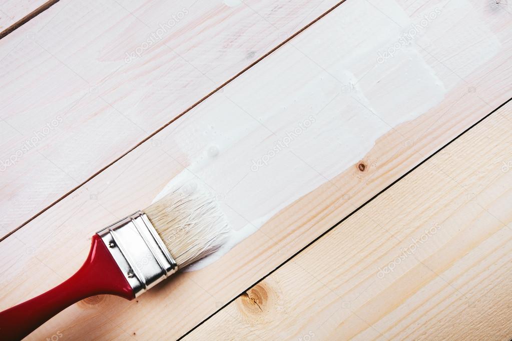 paint brush painting on wooden surface