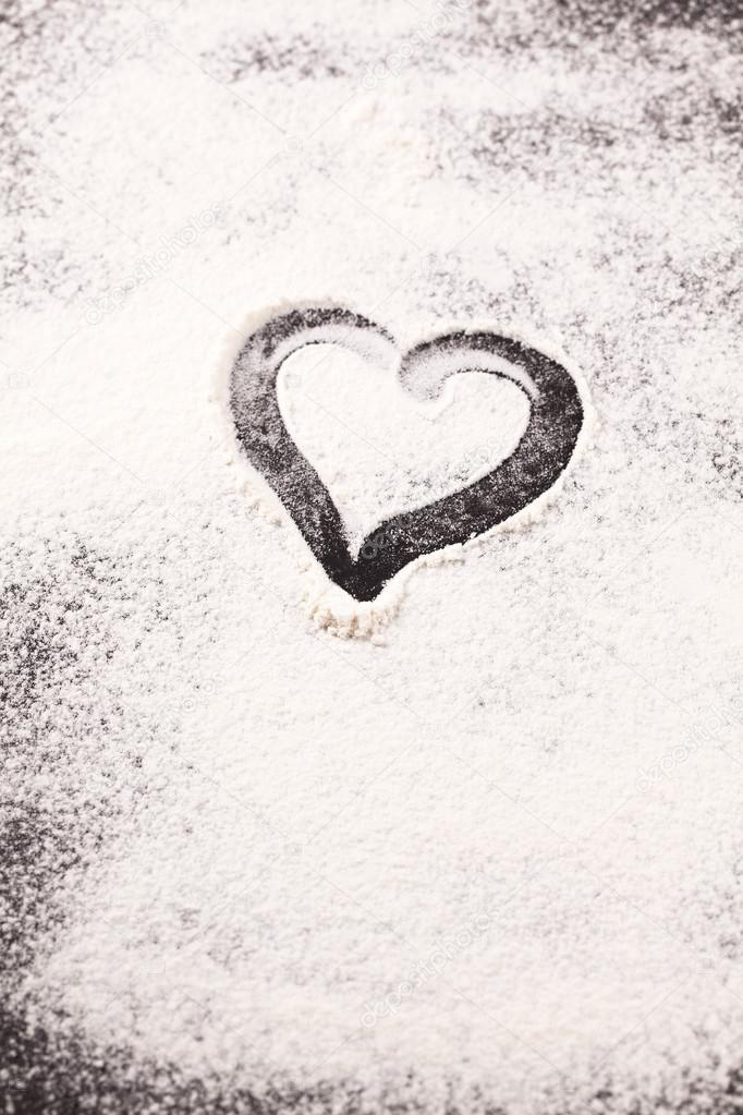 Heart drawn in scattered flour 