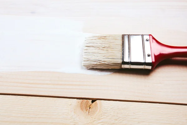 Paintbrush on wooden surface — Stock Photo, Image