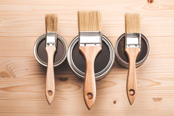 Paint brushes on three cans — Stock Photo, Image