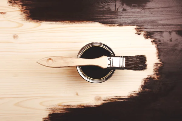 Paint can with brush on wooden background — Stock Photo, Image