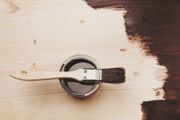Paint can with brush on wooden background — Stock Photo, Image