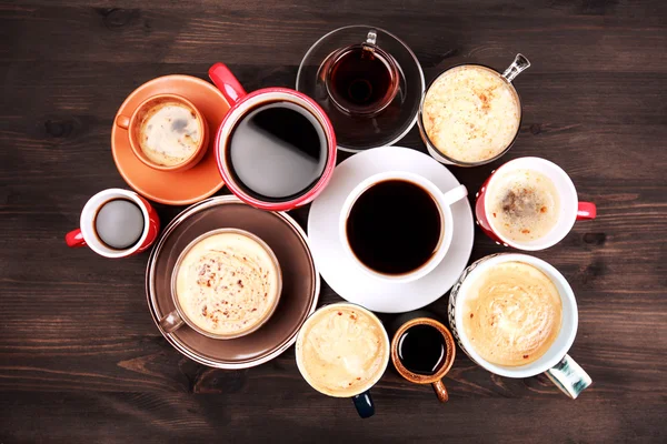 Many cups of coffee on wooden table Stock Photo