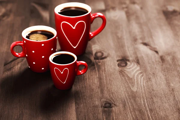 Three red coffee cups