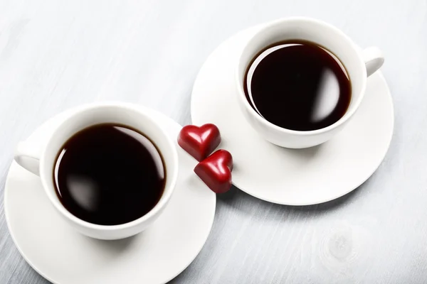 Two cups of coffee and heart shaped sweets — Stock Photo, Image