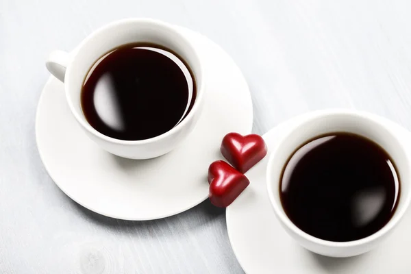 Two cups of coffee and heart shaped sweets — Stock Photo, Image