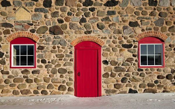 Old Stone Barn with Bright Red Door and Two Windows