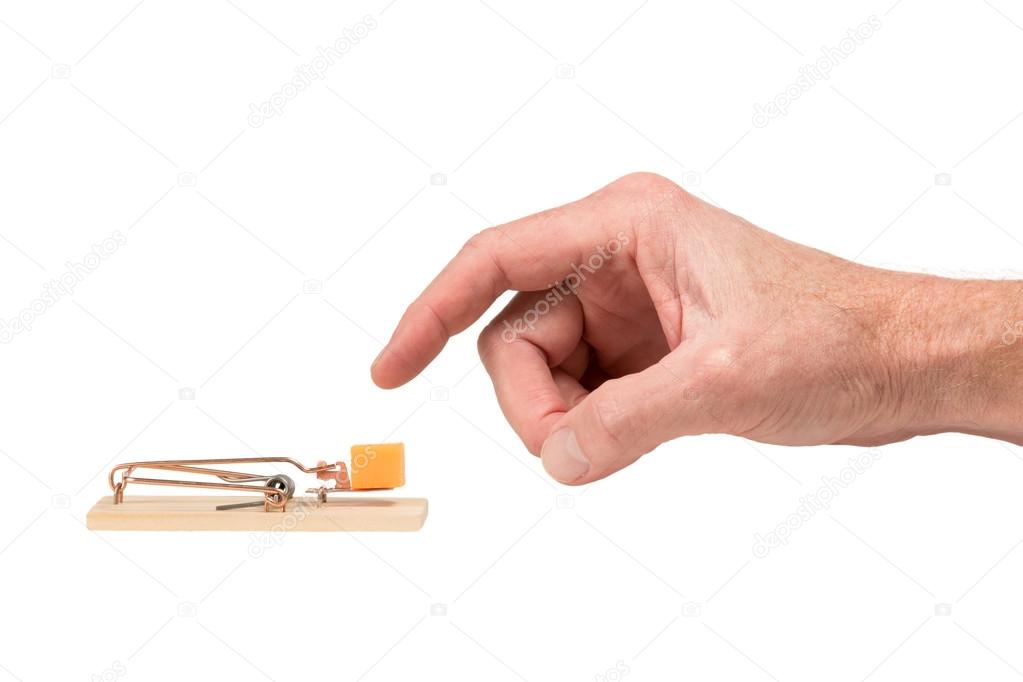 Hand Reaching for Cheese in a Mousetrap