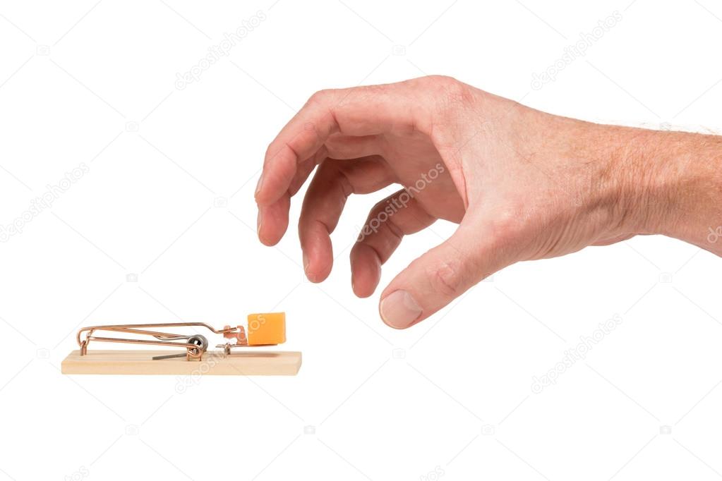 Hand Reaching for Cheese in a Mousetrap