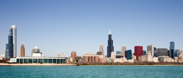 Chicago Skyline panorama captured on a sunny spring morning showcasing the city's skyscrapers and varied architectural styles. Room for your copy in the clear blue sky if needed.