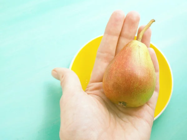 Pear in a hand — Stock Photo, Image