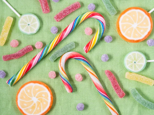 Lolly pops and candies on green napkin — Stock Photo, Image