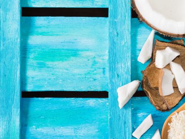 Coconut on bright blue wooden background clipart