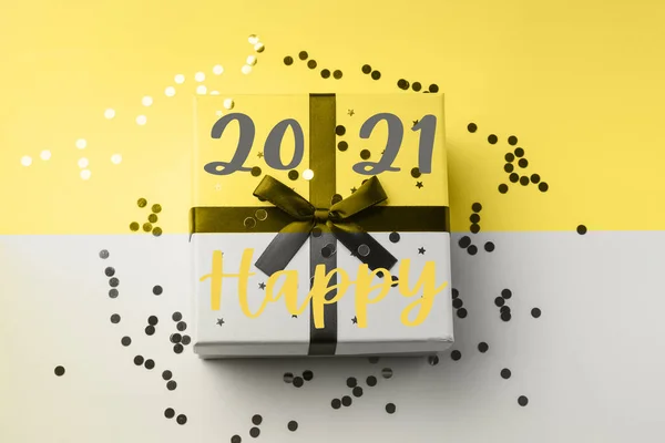 Gift on gray and illuminating yellow. Happy 2021 — Stock Photo, Image