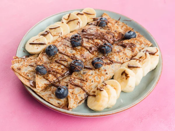 Crepes with chocolate nut spread, banana, berries — Stok Foto