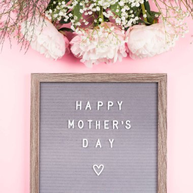 Mutlu anneler günü pembe arkaplanlı mektup panosunda.