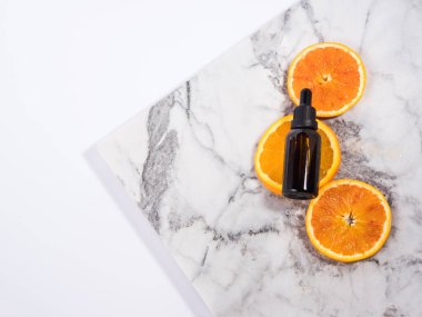 Beyaz mermer kaplamalı C vitamini serumu şişesi.