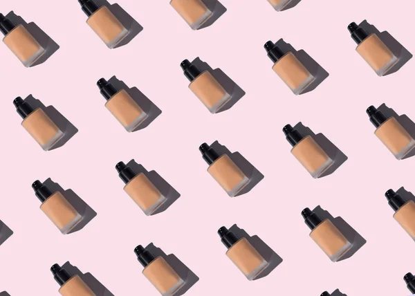 Make up foundation glass bottle pattern on pink — Stock fotografie