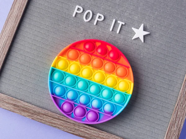 Pop it fidget toys to help reduce stress and anxiety in kids and adults and letter board