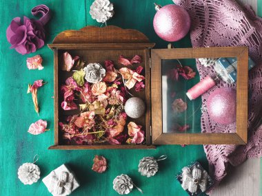Gümüş ve pembe süslemeleri ile kurutulmuş çiçek yeşil ahşap arka plan üzerinde Noel