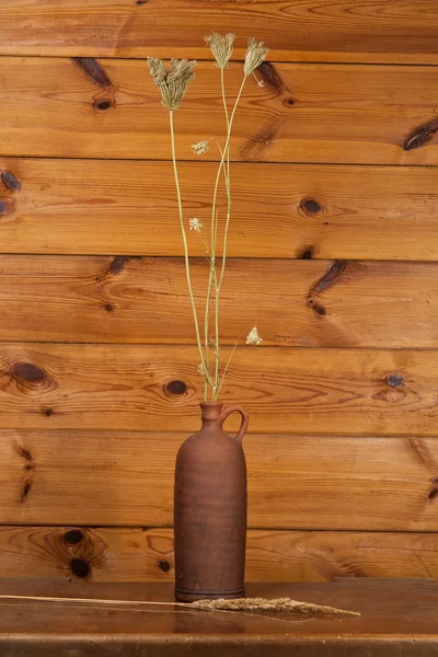 Clay jug with dry stalks of a reed — Stock Photo, Image