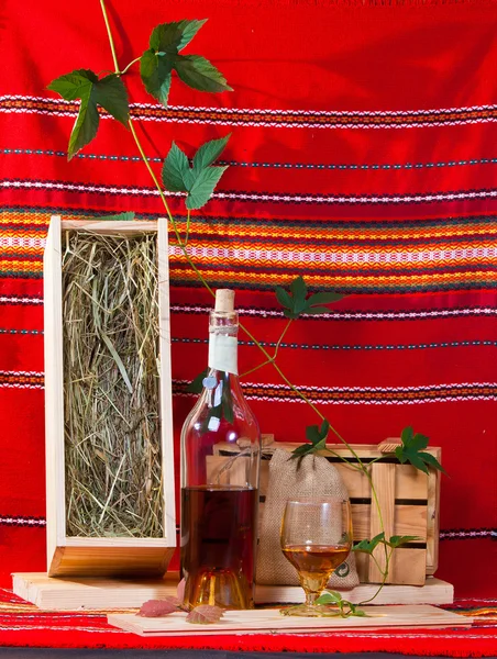 Still-life with a brandy bottle  and grapevine — Stock Photo, Image