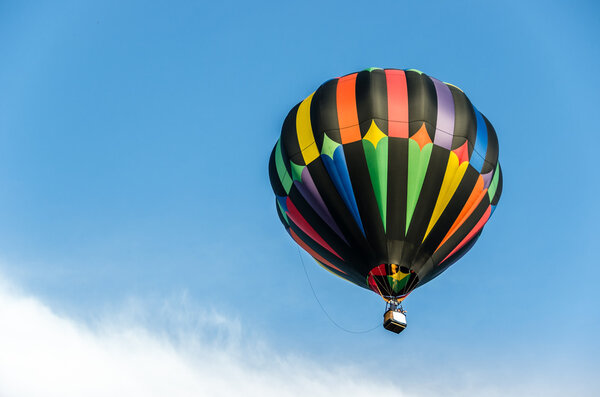 A Beautiful Hot Air Balloon Rising Above The Clouds