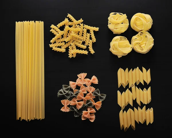 Various Types Pasta On Black Stone Stock Photo 433773259