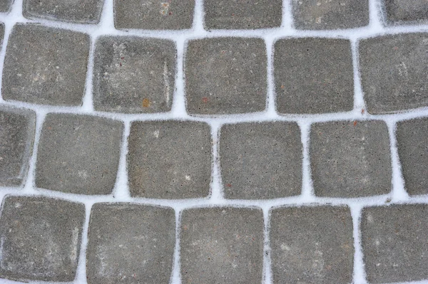 Background of stone tiles on a track covered with snow — Stock Photo, Image