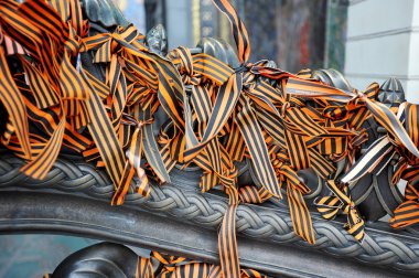 St. George ribbons tied to the iron fence clipart