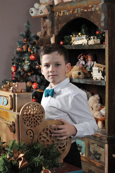 Christmas boy around Christmas tree with gifts — Stock Photo, Image