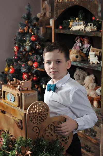 Christmas boy around Christmas tree with gifts — Stock Photo, Image